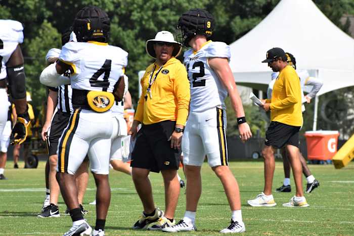 Missouri head coach Eli Drinkwitz talks with quarterback Brady Cook (12) during a preseason practice on August 7, 2022.